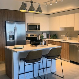 kitchen with ample counter-space, modern appliances and bright lighting