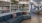 a lounge room with a blue couch and bookshelf