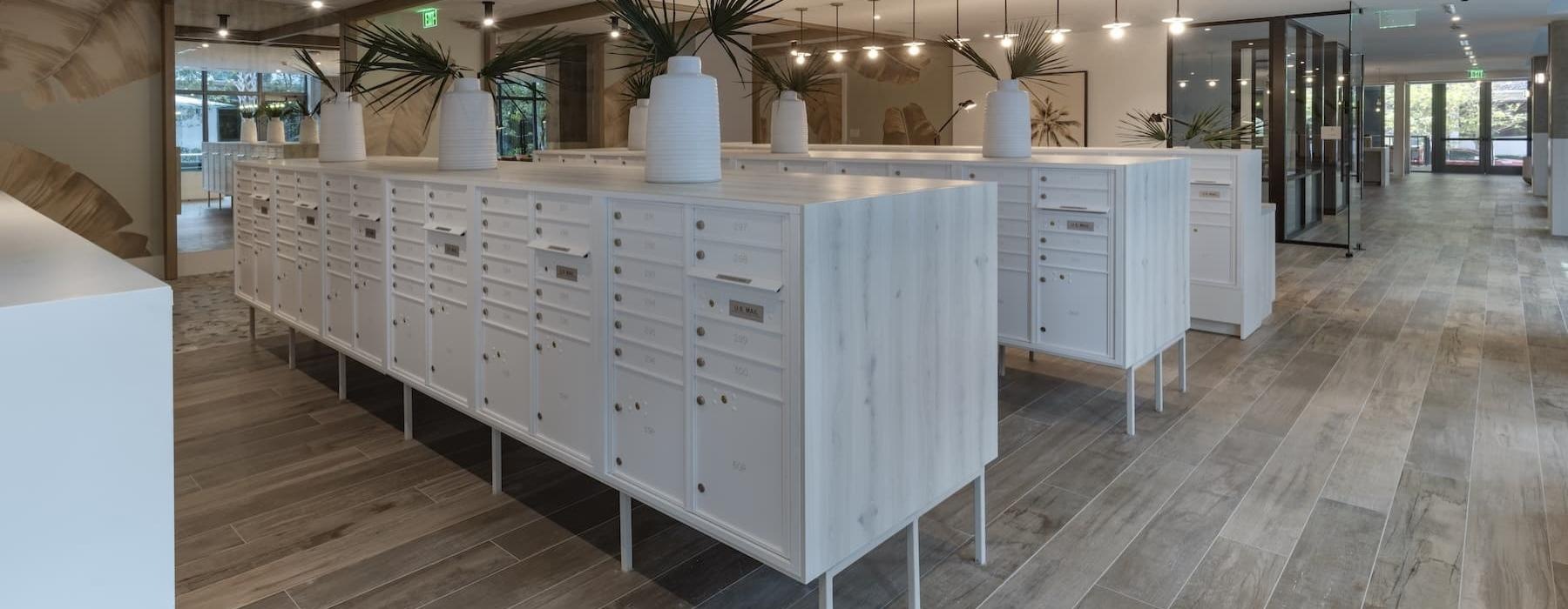 a large white mail cabinet with drawers