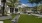 a building with palm trees and a lawn