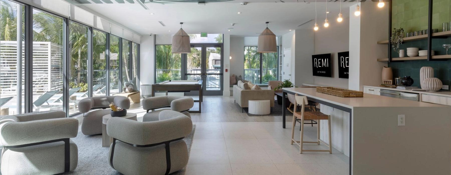a lounge room with a bar and chairs